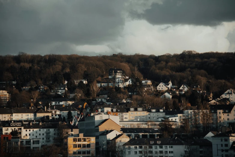 a view of a city from the top of a hill, pexels contest winner, modernism, detmold, gloomy earthy colors, white houses, hd footage