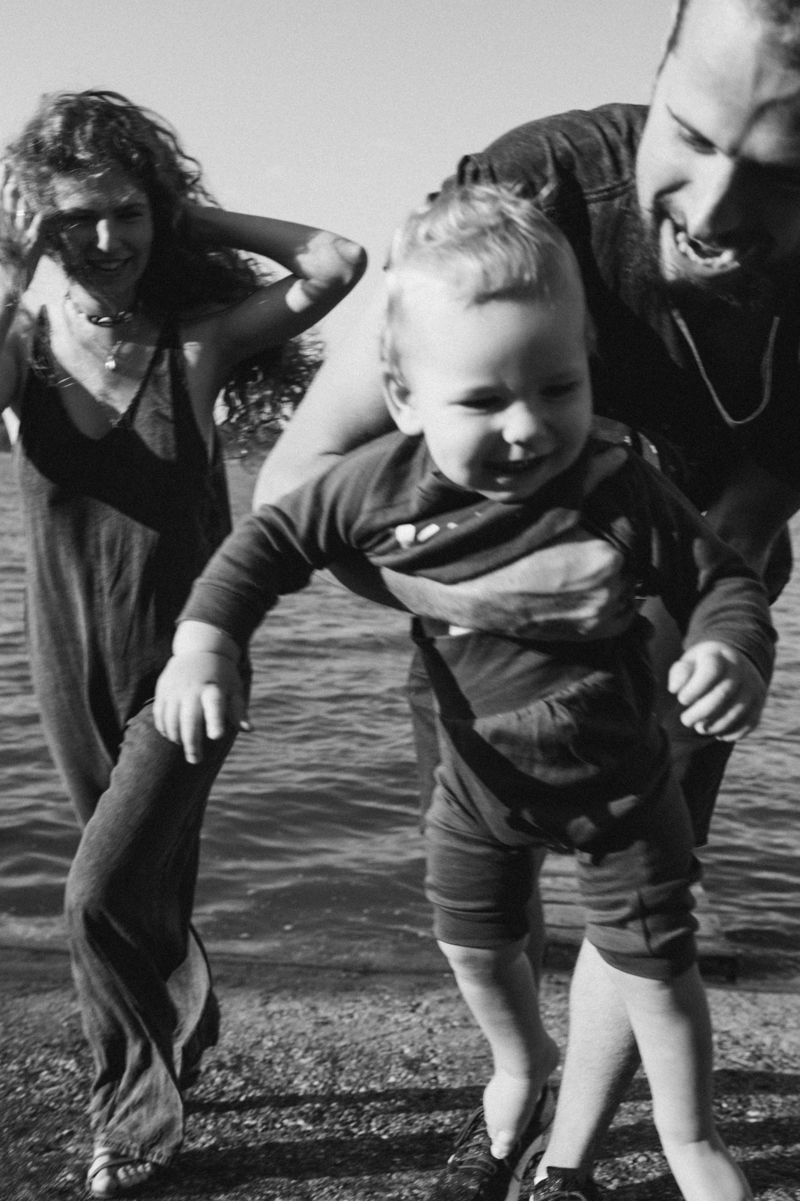 a black and white photo of a family by the water, unsplash, process art, 2 years old, trippy, hipster dad, colours