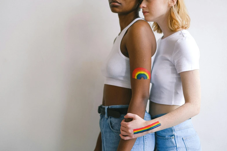 a man and a woman standing next to each other, a tattoo, inspired by Okuda Gensō, trending on pexels, feminist art, college girls, an all white human, bandage on arms, lesbian