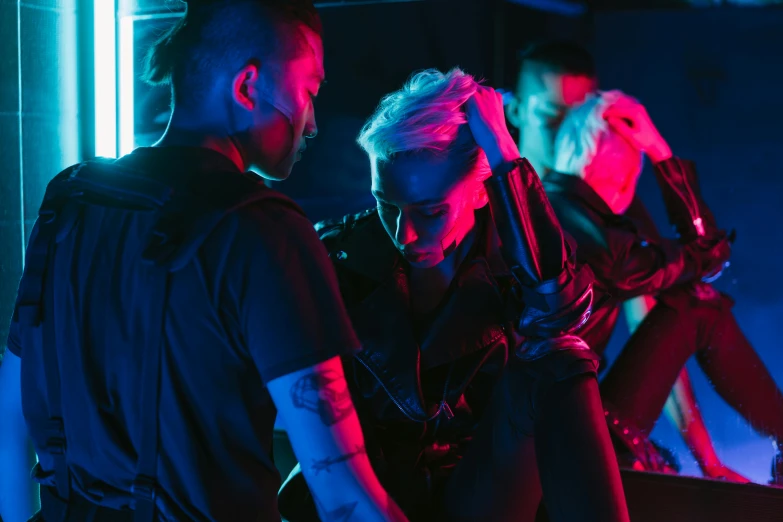 a group of people standing next to each other, cyberpunk art, by Adam Marczyński, pexels contest winner, bisexual lighting, choreographed fight scene, cyberpunk dyed haircut, behind the scenes