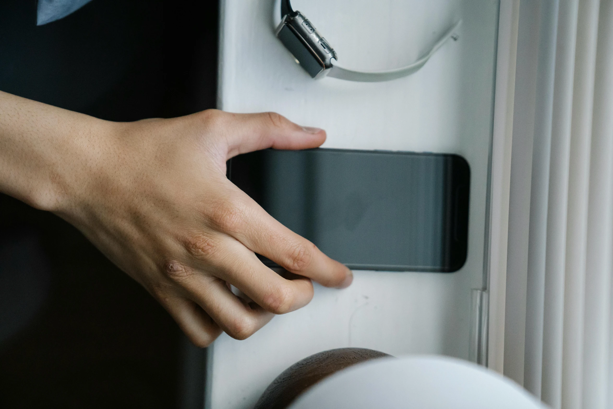 a close up of a person holding a cell phone, a picture, hand on the doorknob, square, shot on sony a 7, domestic