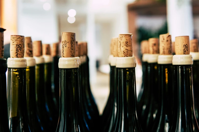 a close up of a bunch of bottles of wine, pexels contest winner, facing away, instagram post, profile image, in rows