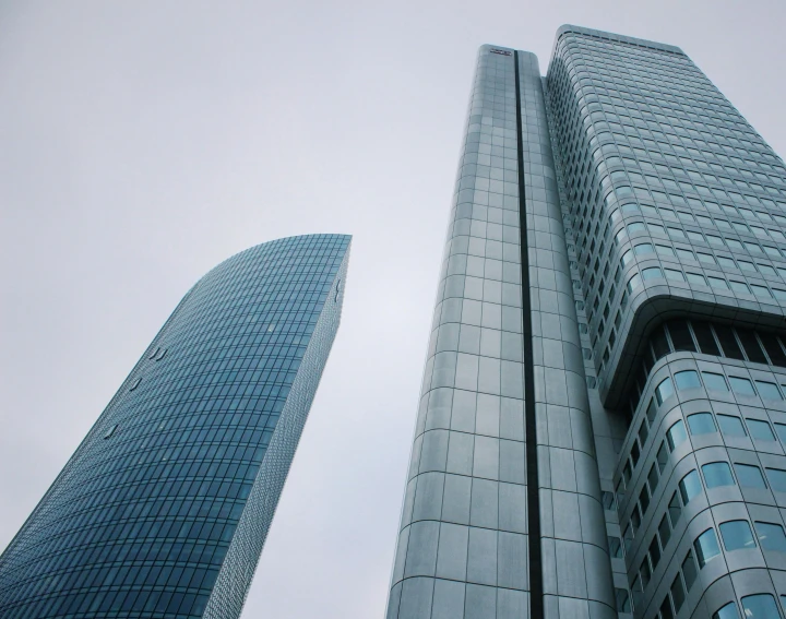 a couple of tall buildings next to each other, a picture, unsplash contest winner, bauhaus, fan favorite, sleek glass buildings, low quality photo, low ultrawide shot