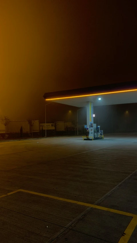 an empty gas station lit up at night, an album cover, pexels, conceptual art, yellow volumetric fog, gif, square, high quality photo