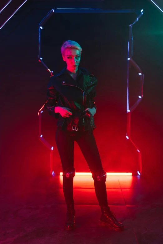 a man standing in front of a neon light, she wears leather jacket, non binary model, joel fletcher, cyber wear