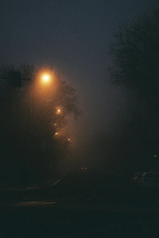 a street light in the middle of a foggy night, an album cover, inspired by Elsa Bleda, ((mist)), moist foggy