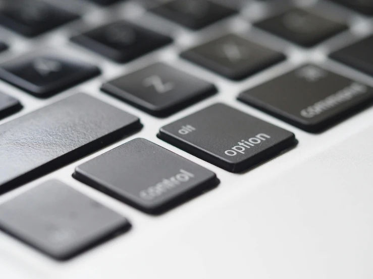 a close up of a keyboard on a laptop, a digital rendering, pexels, black and silver, buttons, engraved, polished : :