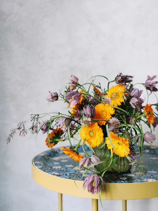 a vase of flowers sitting on top of a table, featured on pinterest, baroque, marigold, purple and yellow, full product shot, grey orange