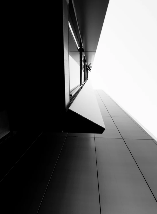 a black and white photo of a tall building, by Matthias Weischer, unsplash, minimalism, morphosis, view from the side”, low angle!!!!, an abstract