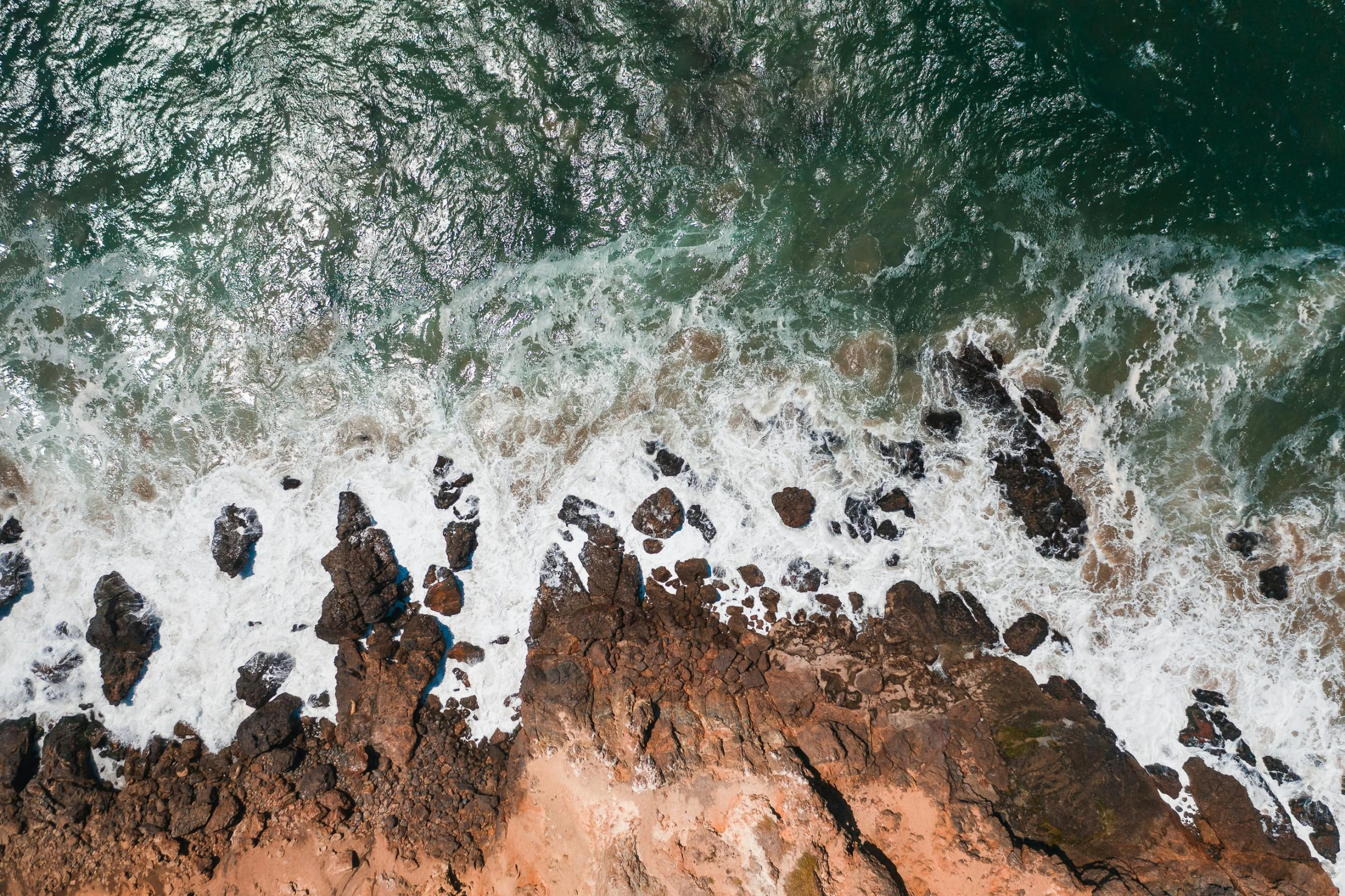 a view of the ocean from a bird's eye view, by Daniel Lieske, pexels contest winner, erosion, brown, profile image, australian beach