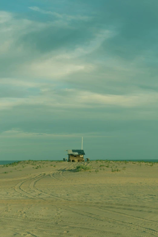 a man flying a kite on top of a sandy beach, inspired by Edward Hopper, unsplash, minimalism, witch hut, square, panoramic, new jersey