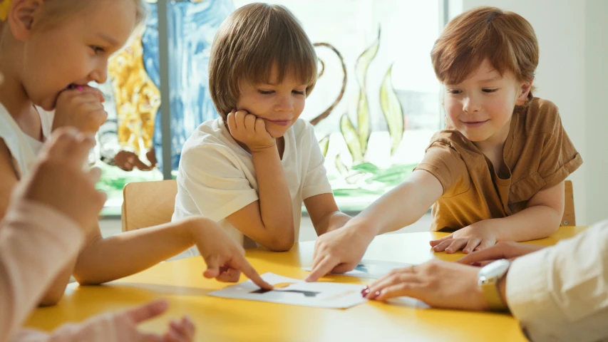 a group of children sitting around a yellow table, school curriculum expert, profile image, thumbnail, high quality image