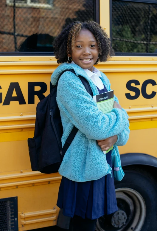 a young girl standing in front of a school bus, teal uniform, essence, next gen, academic clothing