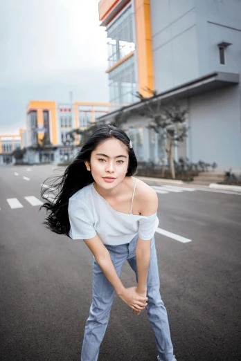 a woman standing in the middle of a street, a picture, inspired by Cheng Jiasui, trending on pexels, photorealism, handsome girl, medium format, young cute wan asian face, grey
