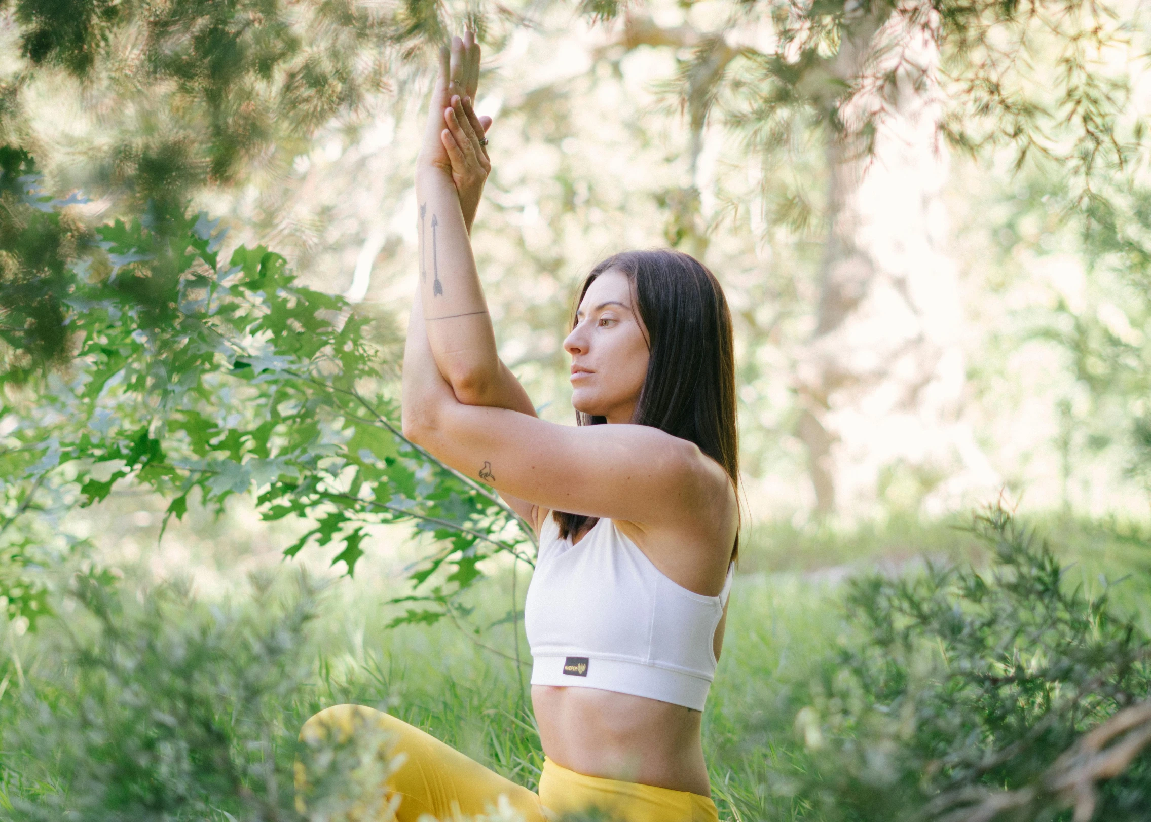 a woman doing a yoga pose in the woods, unsplash, arabesque, wearing yellow croptop, avatar image, half body photo, sitting in a tree