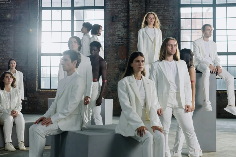 a group of people dressed in white posing for a picture, inspired by Vanessa Beecroft, antipodeans, aurora aksnes and zendaya, in a warehouse, tailored clothing, thumbnail