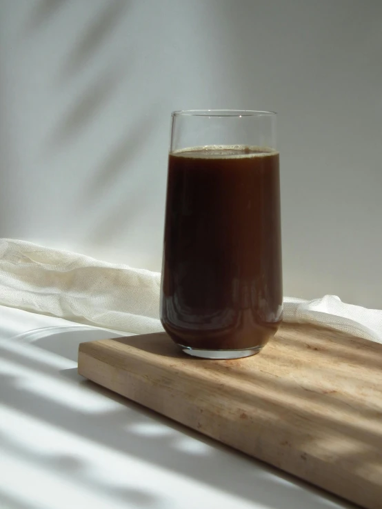 a glass of coffee sitting on top of a wooden cutting board, inspired by Ceferí Olivé, hurufiyya, full front view, cold brew coffee ), 165 cm tall, jakarta