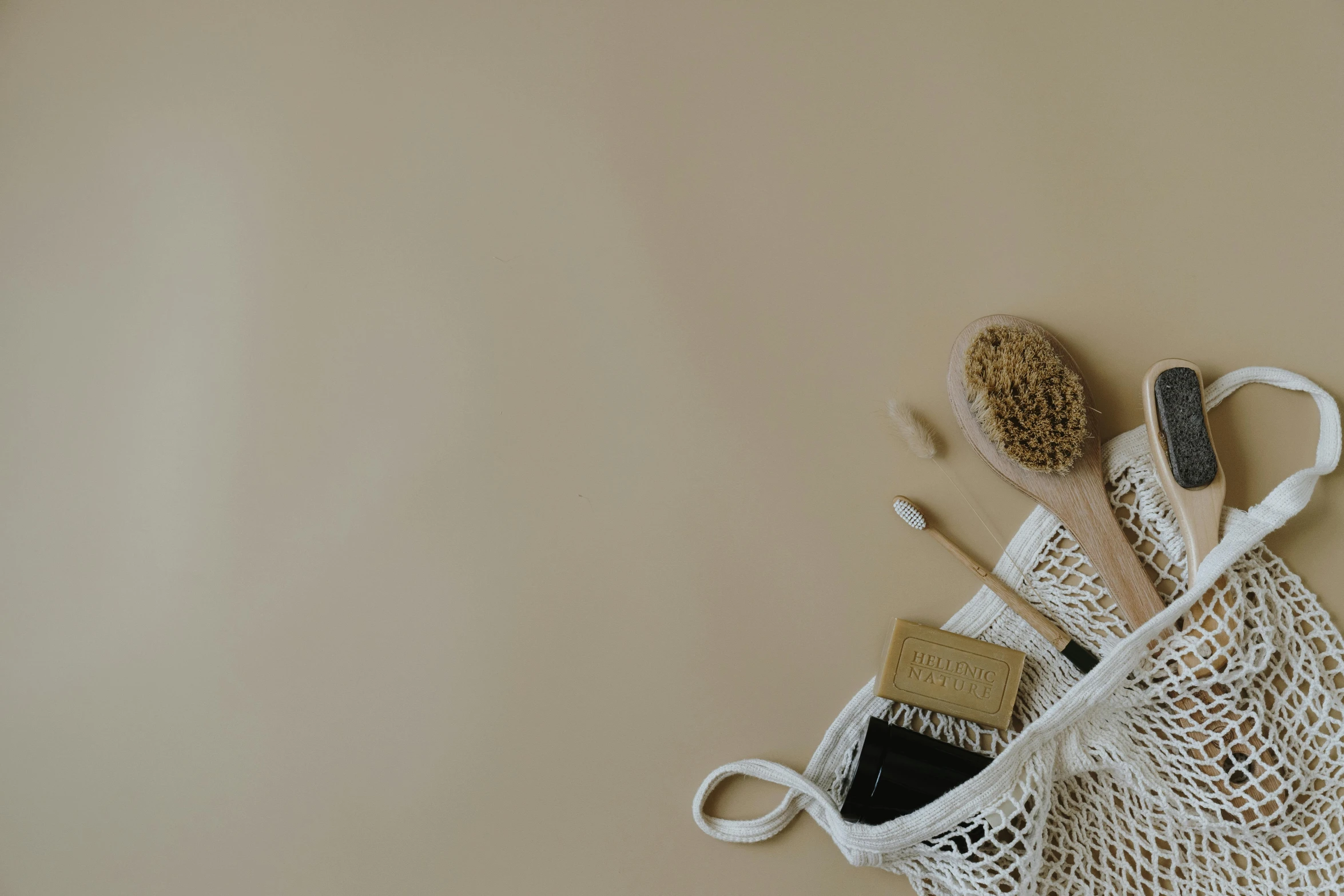 a mesh bag filled with tools sitting on top of a table, unsplash, minimalism, soap, background image, beige, macrame