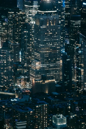 an aerial view of a city at night, an album cover, unsplash contest winner, new york buildings, 8 k detail, ignant, zoomed in