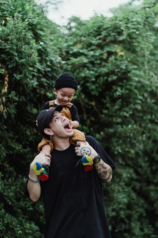 a man carrying a child on his shoulders, unsplash, realism, pete davidson, mickey mouse ears, tyler edlin and natasha tan, on trees