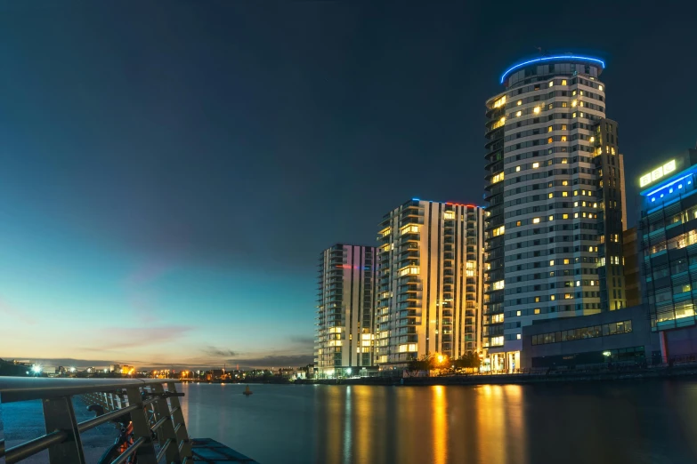 a group of tall buildings next to a body of water, pexels contest winner, bauhaus, london at night, 3 6 0 panorama, manchester, slide show