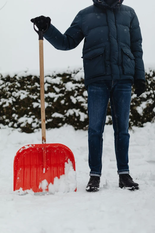 a person standing in the snow with a snow shovel, a photo, pexels, conceptual art, rectangle, gardening, slightly red, gif