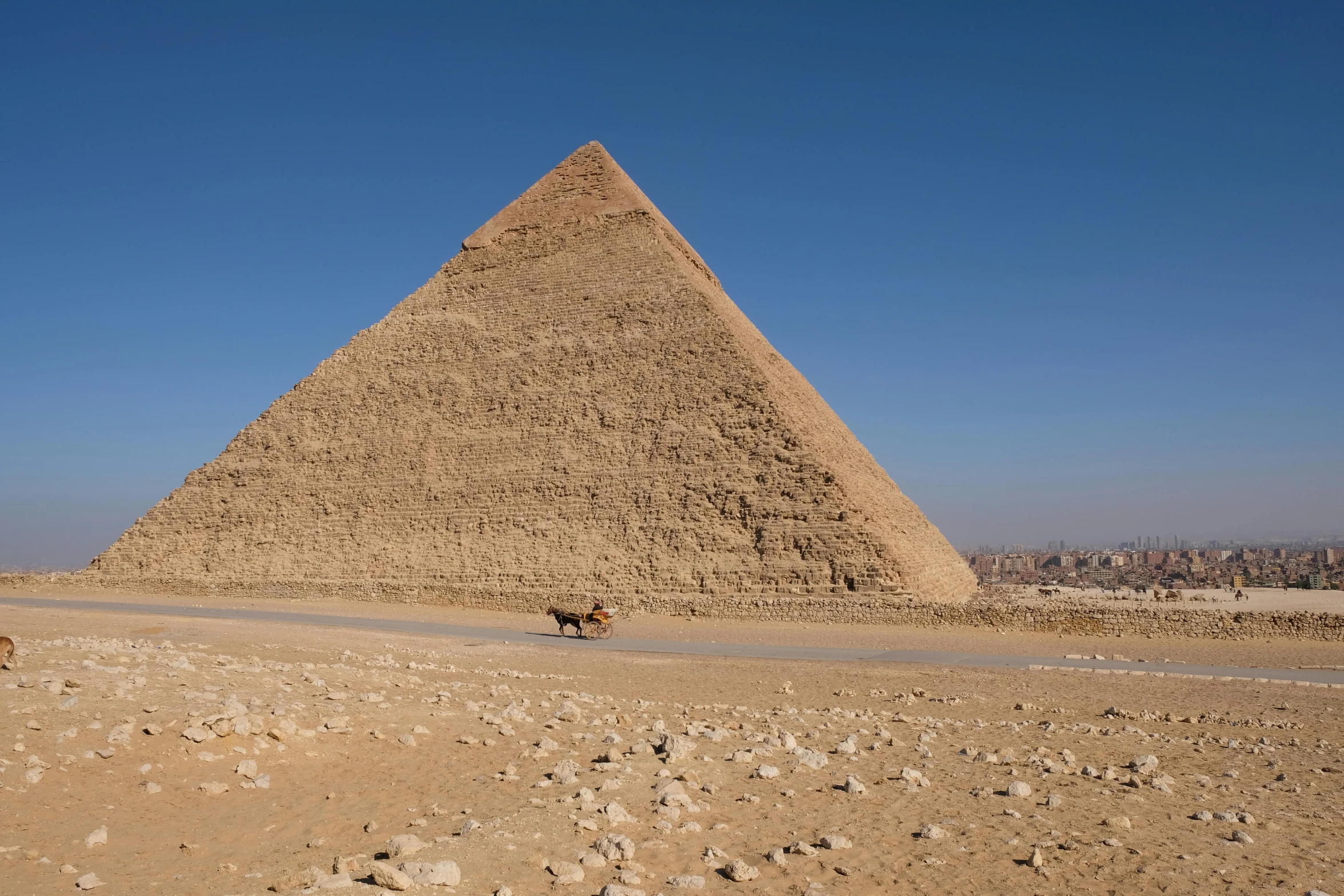 a man riding a horse in front of a pyramid, pexels contest winner, les nabis, national geograph, side view from afar, brown, hyperdetailed