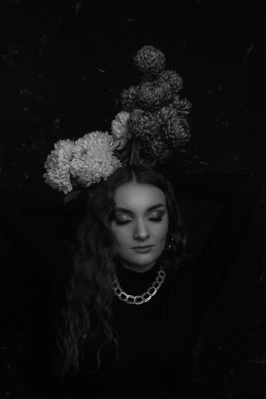 a black and white photo of a woman with flowers on her head, inspired by Maud Naftel, unsplash, florence pugh, album cover, low quality photograph, late evening