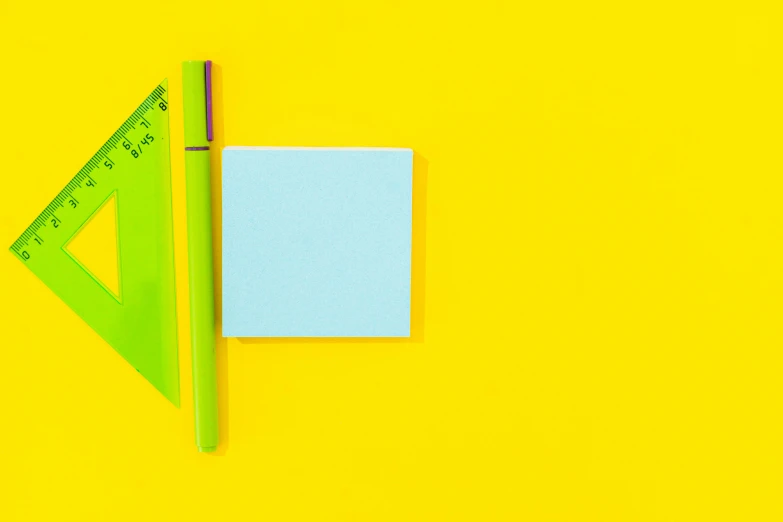 a piece of paper and a ruler on a yellow background, by Jan Rustem, trending on pexels, postminimalism, green square, colorful plastic, ( ( colored pen ) ), blue and yellow ribbons