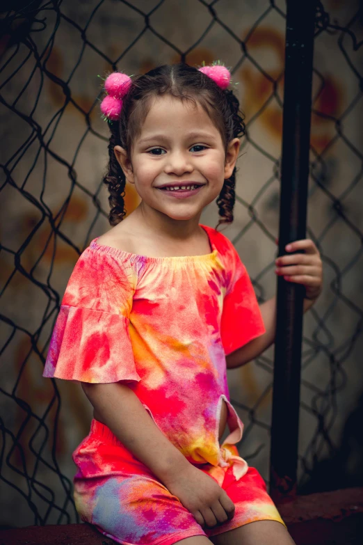 a little girl posing for a picture in front of a fence, a portrait, inspired by Samuel Silva, wearing a tie-dye shirt, neon colored dress, portrait shot 8 k, by greg rutkowski