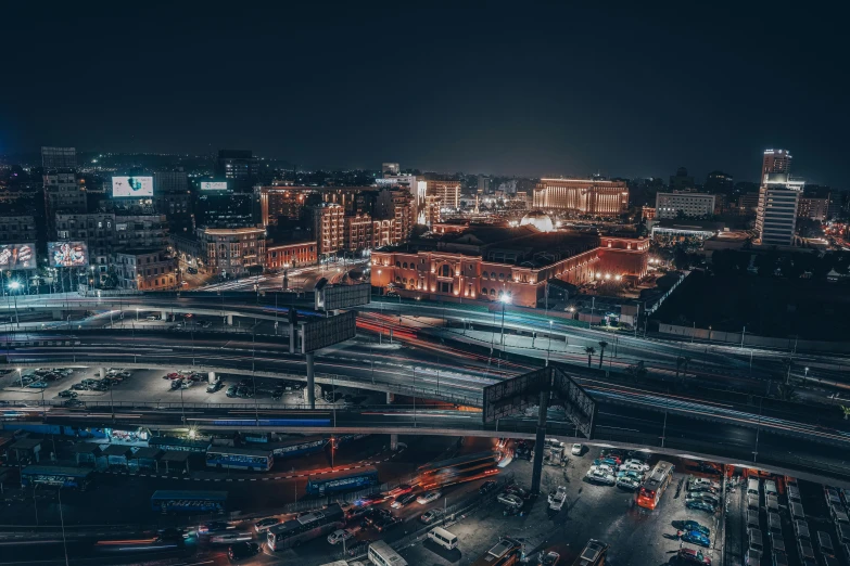 an aerial view of a city at night, by Adam Marczyński, pexels contest winner, train station background, neo kyiv, mongolia, coventry city centre