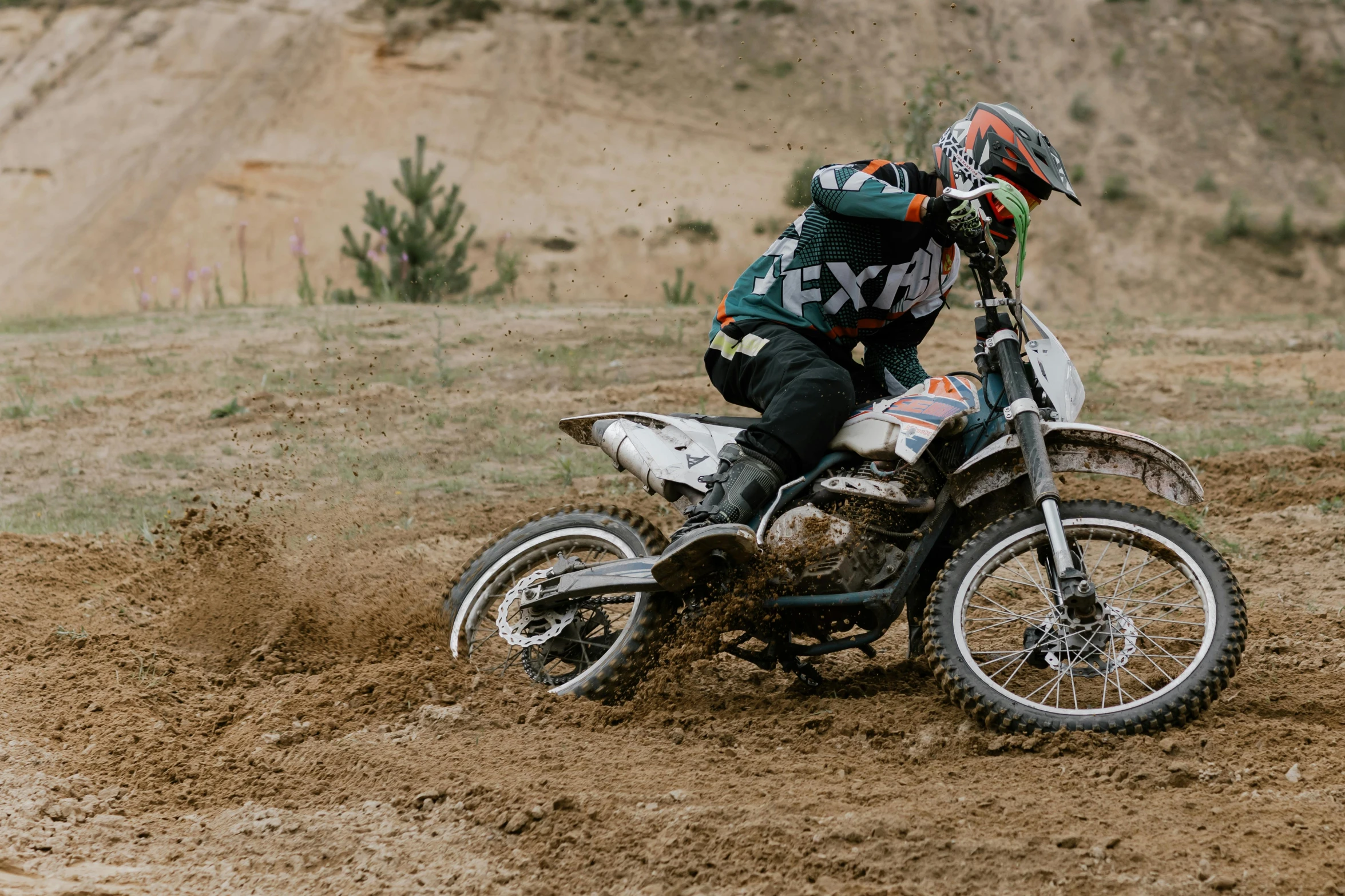 a man riding on the back of a dirt bike, a picture, unsplash, performance, full faced, gray, brown