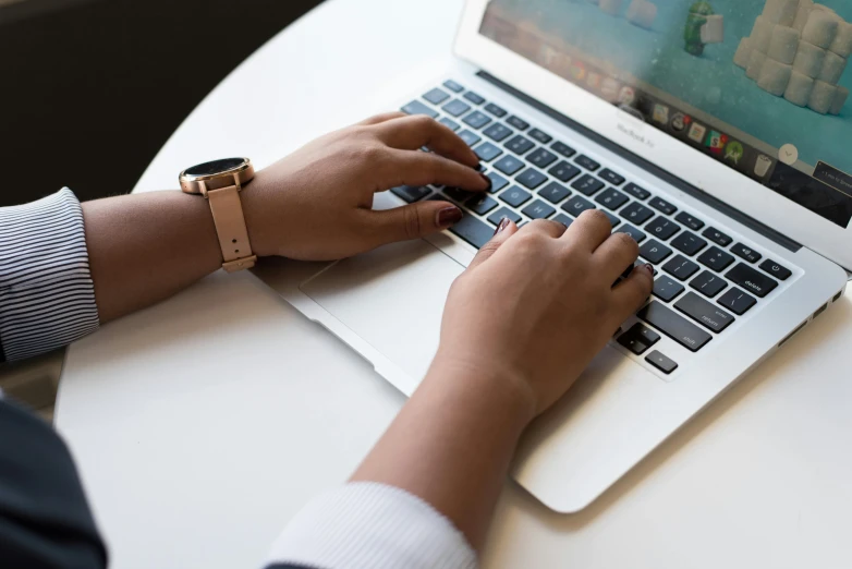 a close up of a person typing on a laptop, by Carey Morris, trending on unsplash, laying down with wrists together, apple, thumbnail, multiple stories