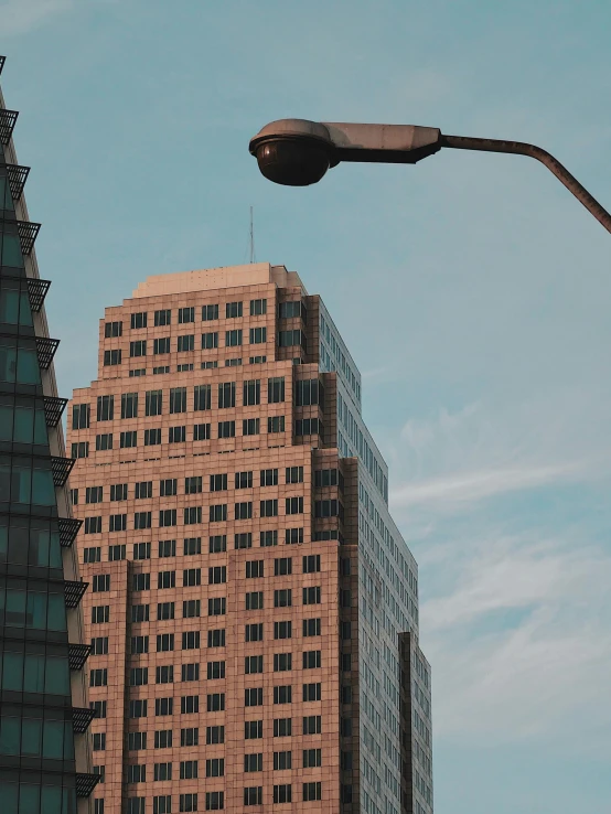 a street light in front of a tall building, unsplash contest winner, brutalism, low quality photo, 2 0 0 0's photo, highrise business district, worm\'s eye view