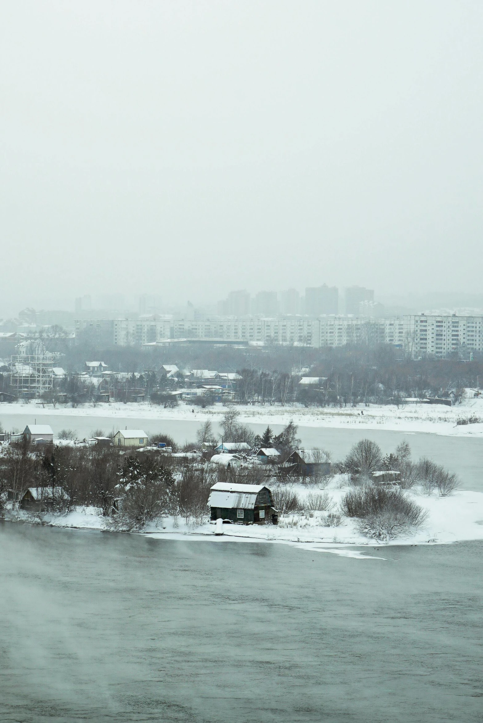 a train traveling down a train track next to a river, a tilt shift photo, inspired by Alexei Kondratyevich Savrasov, snowstorm ::5, super wide view of a cityscape, фото девушка курит, wide river and lake