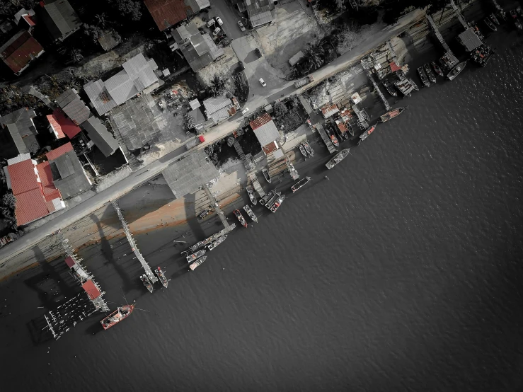 an aerial view of a city next to a body of water, a black and white photo, pexels contest winner, digital art, red selective coloring, shipping docks, thumbnail, grey