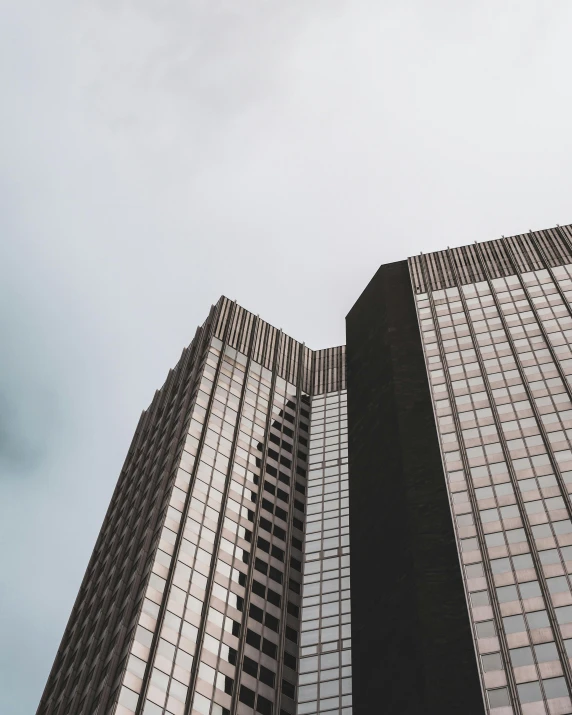 a couple of tall buildings sitting next to each other, a photo, unsplash contest winner, thumbnail, multiple stories, low quality photo, exterior view