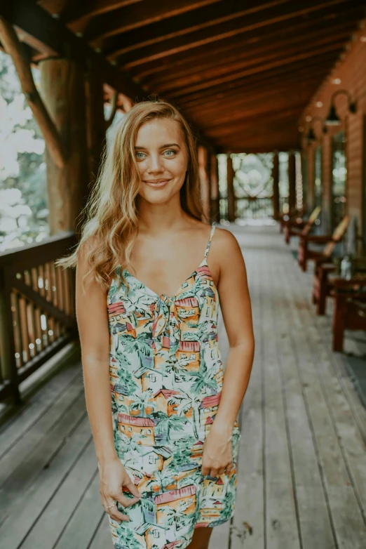 a woman standing on a porch in a dress, a portrait, unsplash, cute girl wearing tank suit, jungle in background, brooke ashling, patterned