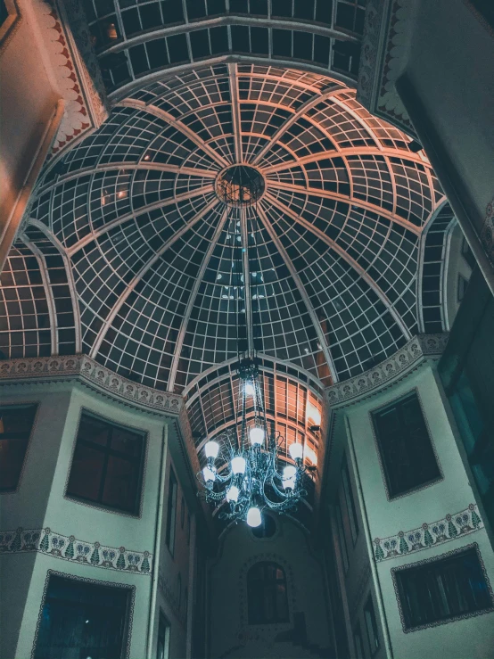 a chandelier hanging from the ceiling of a building, inspired by Sydney Prior Hall, unsplash contest winner, gopro photo, profile image, dome, from the grand budapest hotel