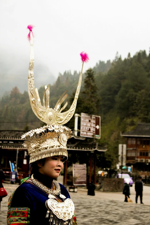 a close up of a person wearing a hat, inspired by Miao Fu, zhangjiajie national forest park, queen crown on top of her head, village, slide show