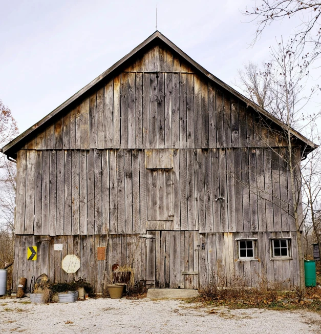 an old barn sitting on the side of a road, a portrait, architectural digest photo, maple syrup, gray, high - resolution