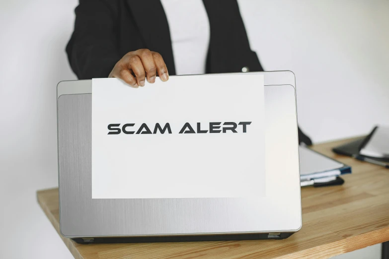 a woman holding a laptop with the word scam alert on it, pexels, computer art, silver, white, instagram post, ad image