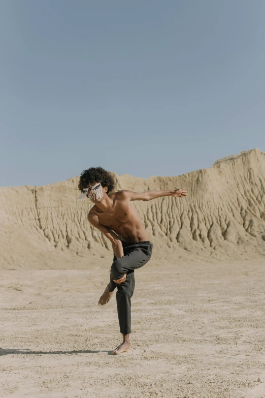 a man doing a trick on a skateboard in the desert, pexels contest winner, surrealism, classic dancer striking a pose, imaan hammam, face covered in dirt, ballet style pose