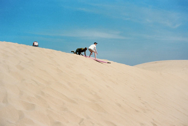 a man riding a surfboard on top of a sandy beach, an album cover, by Ren Hang, pexels contest winner, desert dunes, a dog, william eggleston, listing image