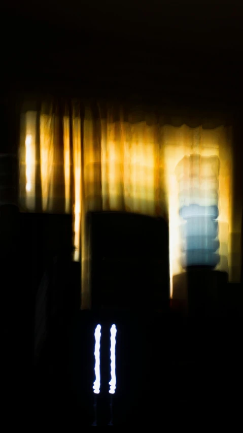 a blurry photo of a building at night, inspired by Elsa Bleda, realism, curtain, morning sunlight, two still figures facing camera, television