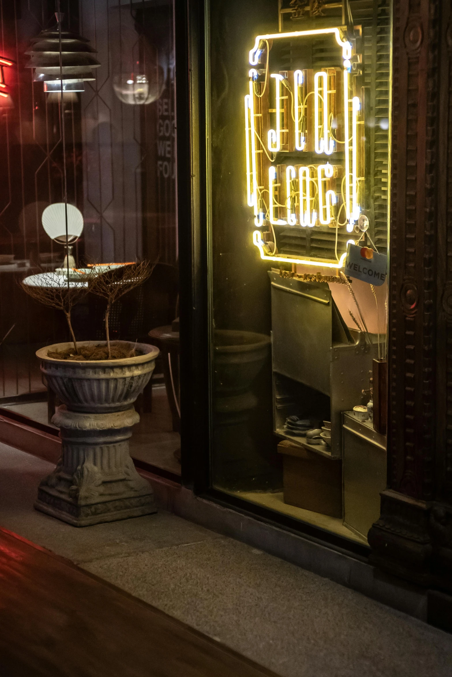 a neon sign that is on the side of a building, an art deco sculpture, art nouveau, overturned ornate chalice, warm lighting interior, miniature cafe diorama, rene lalique and eddie mendoza