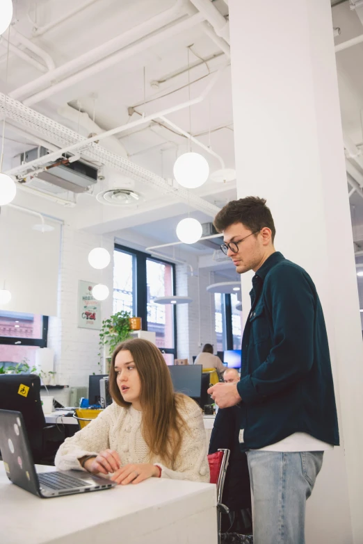 a couple of people that are standing in front of a desk, trending on unsplash, side view future coder man, 9 9 designs, pokimane, high resolution photo