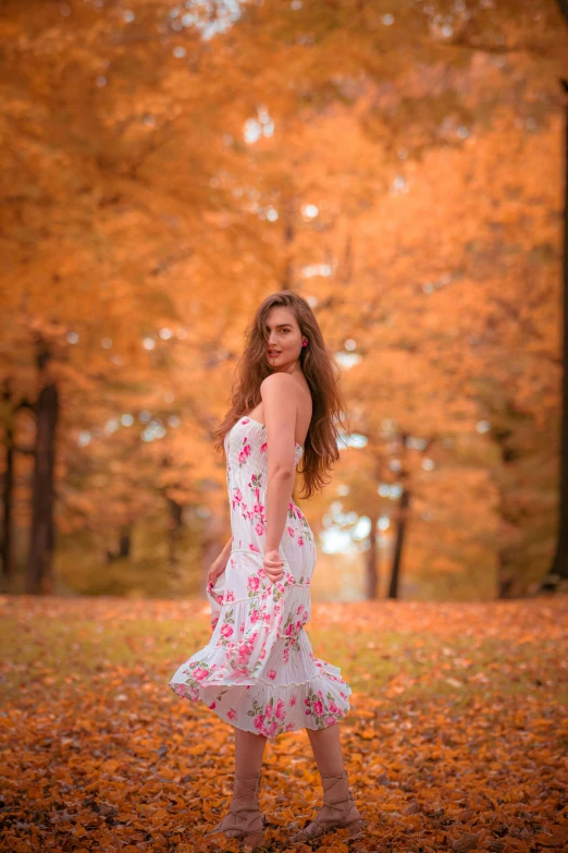 a woman standing in the middle of a field of leaves, by Antoni Brodowski, square, very pretty model, white and orange, medium-shot