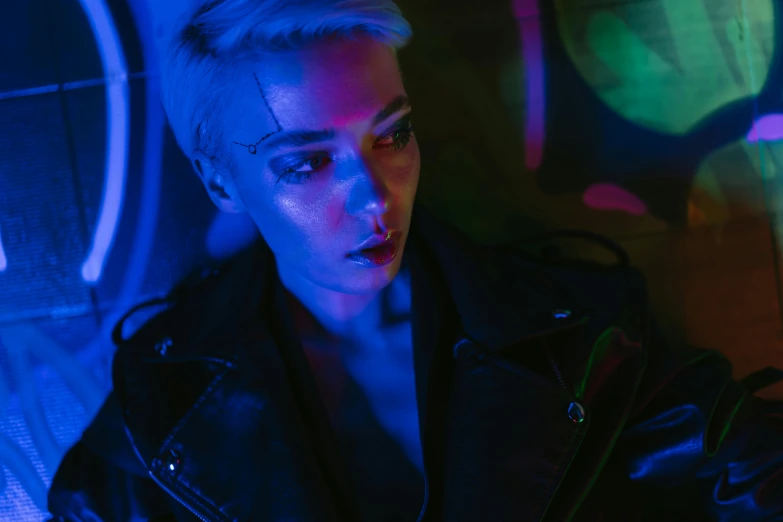 a close up of a person wearing a leather jacket, cyberpunk art, inspired by Elsa Bleda, trending on pexels, blue lights, non binary model, beeple and james jean, girl with short white hair
