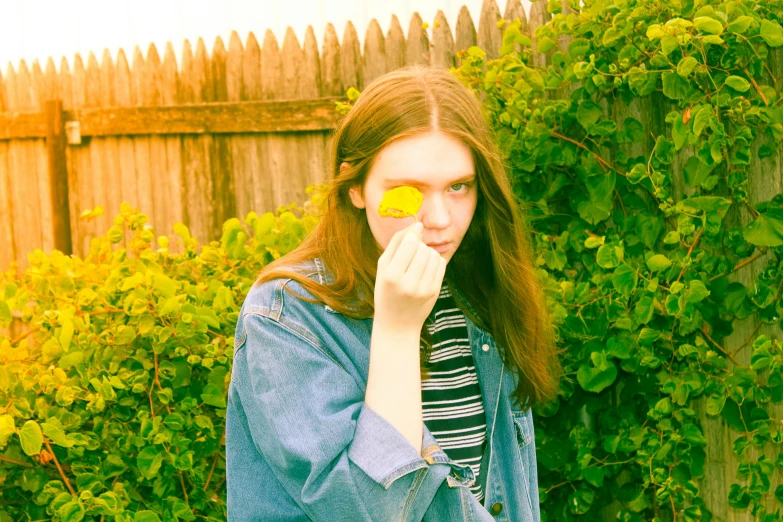 a woman holding a lemon in front of her face, an album cover, inspired by Elsa Bleda, tumblr, in a garden, dslr photo of a pretty teen girl, pale skin!, cottagecore hippie